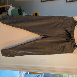 Grey tie joggers with side pockets.